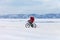 A girl travels in winter on a bicycle on the ice of the frozen Baikal Lake