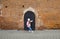 A girl tries to open the door of a medieval fortress