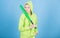 Girl troublemaker. Woman play baseball game or going to beat someone. Girl hooded jacket hold baseball bat blue