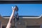 Girl trowing away her bikini bra out from open hatch of a vehicle.