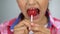 Girl trying to bite lollipop, bad effect of sugar on teeth, dental care concept