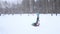 Girl tumbles and does first tumbling pass during snowfall at winter