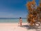 Girl on turquoise water and white beach in Camiaran island in Balabac in Philippines