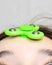 The girl twists the fidget spinner stress relief toy on her forehead