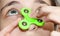 A girl twists a fidget spinner stress relief toy on her nose