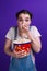 Girl with two buns watch tv show and eating popcorn bucket mouth open, thrill exciting plot, isolated blue background