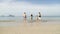 Girl And Two Couple Running In Water Holding Hands, People On Beach Tourists