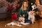 Girl with two dogs of husky near Christmas tree