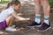 Girl tying her grandfathers shoe laces