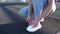 Girl tying her shoelaces on the running ground,