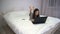 Girl is typing behind laptop lying on bed