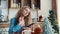 Girl typing a message in the smartphone in the morning in the kitchen