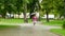 Girl with an umbrella jumping on an empty park