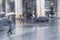 Girl under the umbrella, rainy weather, abstract, blurred motion. View through glass window with rain drops on glass