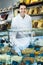 Girl in uniform selling candied fruits and nuts