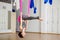 Girl in upside down inversion pose on pink silk hammock