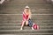 Girl on US Independence Day. The blonde is sitting on the steps after the holiday. USA Independence Day, America flag scarf