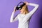 Girl use modern technology vr headset. Enjoy virtual reality. Woman hold vr headset glasses violet background. Digital