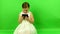 Girl uses electronic reader. Smalll girl on chroma key background.