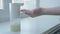 Girl using automatic foam soap dispenser, washing hands, close, macro, on the windowsill, left hand