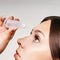 Girl using eye drops. Anti glaucoma recovery. Healthy medicine solution. Woman