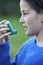 Girl Using Inhaler To Treat Asthma Attack