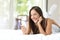 Girl using a mobile phone on the bed at home