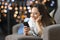 Girl using a smart phone lying on a sofa at home