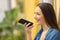 Girl using voice recognition on phone in a colorful street