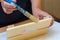 Girl varnishes a wooden detail