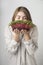 Girl vegetarian enjoying smell of fresh sprouted microgreens