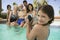 Girl With Video Camera Recording Family In Swimming Pool