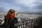 Girl viewing Paris through telescope