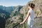 Girl at Viewpoint Eira do Serrado looking to Curral das Freiras village in the Nuns Valley in beautiful mountain scenery,