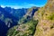 Girl at Viewpoint Eira do Serrado looking to Curral das Freiras village in the Nuns Valley in beautiful mountain scenery,