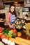 Girl with a vintage haircut in the kitchen among vegetables with a tray with baked cookies