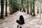 Girl with a vintage suitcase in the park. Beautiful dreamy girl portrait. Traveler with retro luggage. Romantic girl outdoors