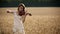 Girl violinist playing the violin in wheat field.