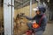 Girl, volunteer, petting stray dog sitting behind bars in the cage. October 4, 2019. Municipal animal shelter.  Borodyanka, Ukrain