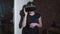 Girl in VR glasses is stands and talks commenting some things