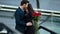 Girl waiting for guy outdoors. Couple hugging with red roses at street