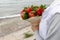 Girl is waiting on the seashore for the return of her boyfriend with a bouquet in her hands