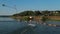 Girl wakeboarder riding the lake water. Aerial shot of a cableway in a lake.