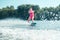 Girl wakeboarding on a local river in summer
