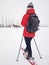 Girl walk with snowshoes at snowy horse paddock on hill