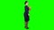 Girl is walking along the street with a folder in her hands. Green screen. Side view