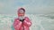 Girl walking on cracked ice of a frozen lake Baikal. Woman traveler explores and looks at an ice floe. It is magical