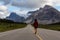 Girl walking down a scenic road in the Canadian Rockies