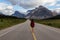Girl walking down a scenic road in the Canadian Rockies