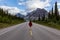 Girl walking down a scenic road in the Canadian Rockies